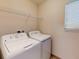 Dedicated laundry space with a washer, dryer, and wire shelving for organized storage at 468 Bouchelle Dr # 128, New Smyrna Beach, FL 32169