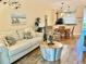 Comfortable living area featuring a cozy couch, unique coffee table, and views into the dining and kitchen area at 468 Bouchelle Dr # 128, New Smyrna Beach, FL 32169
