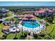 A gorgeous pool with spa and lounging chairs surrounded by a white fence and swaying palms at 468 Bouchelle Dr # 128, New Smyrna Beach, FL 32169