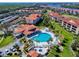 A beautiful aerial view of a condo community featuring a heart shaped pool, clubhouse, and manicured lawns at 468 Bouchelle Dr # 128, New Smyrna Beach, FL 32169