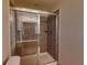 Bathroom with a tiled shower featuring a glass door and a built-in shelf at 468 Bouchelle Dr # 128, New Smyrna Beach, FL 32169