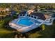 Aerial view of the pool, patio, and tennis courts shows the layout of the building and surrounding landscaping at 481 Sweet Bay Ave, New Smyrna Beach, FL 32168