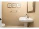 Half bath featuring a pedestal sink, neutral walls, and clean design at 481 Sweet Bay Ave, New Smyrna Beach, FL 32168