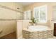 Luxurious bathroom featuring a soaking tub, glass enclosed shower, and stylish mosaic tile accents at 481 Sweet Bay Ave, New Smyrna Beach, FL 32168