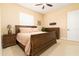 Cozy bedroom featuring a wood sleigh bed, ceiling fan and a large window with plantation shutters at 481 Sweet Bay Ave, New Smyrna Beach, FL 32168