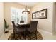 Cozy breakfast nook featuring plantation shutters, a modern chandelier, and a square table with six chairs at 481 Sweet Bay Ave, New Smyrna Beach, FL 32168
