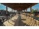 Outdoor seating area with wood deck and pavilion cover offering tables and chairs with views of community amenities at 481 Sweet Bay Ave, New Smyrna Beach, FL 32168