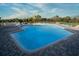 Inviting community pool with crystal-clear water and comfortable lounge chairs under a sunny, clear sky at 481 Sweet Bay Ave, New Smyrna Beach, FL 32168