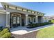 Covered porch with stone accents, decorative columns, and lush landscaping at 481 Sweet Bay Ave, New Smyrna Beach, FL 32168