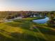 Scenic aerial of lush green golf course with mature trees, sand traps, and beautiful water features at 481 Sweet Bay Ave, New Smyrna Beach, FL 32168