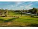 Beautiful golf course view highlighting the putting green, sand trap, mature palm trees, and blue skies at 481 Sweet Bay Ave, New Smyrna Beach, FL 32168