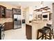 Eat-in kitchen featuring stainless steel appliances, island with seating, and lots of cabinet space at 481 Sweet Bay Ave, New Smyrna Beach, FL 32168