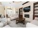 Comfortable living room featuring stone fireplace, custom built-ins, and lots of natural light at 481 Sweet Bay Ave, New Smyrna Beach, FL 32168