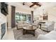 Comfortable living room featuring stone fireplace, custom built-ins, and easy access to the kitchen at 481 Sweet Bay Ave, New Smyrna Beach, FL 32168