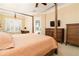 Bright and spacious main bedroom with a four-poster bed, sitting area, and access to the backyard at 481 Sweet Bay Ave, New Smyrna Beach, FL 32168