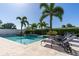 Backyard pool with an in-ground spa, tropical landscaping, and comfortable lounge chairs at 481 Sweet Bay Ave, New Smyrna Beach, FL 32168