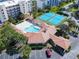 Aerial view of pool, clubhouse, tennis courts, and covered parking at 5300 S Atlantic Ave # 14-202, New Smyrna Beach, FL 32169