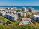 Aerial shot of a beachfront community with multiple buildings and a swimming pool at 5300 S Atlantic Ave # 14-202, New Smyrna Beach, FL 32169