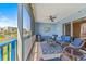 Cozy balcony with blue furniture and a beautiful view of the surrounding buildings and greenery at 5300 S Atlantic Ave # 14-202, New Smyrna Beach, FL 32169