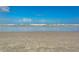 Wide sandy beach with clear ocean water stretching to the horizon under a blue sky at 5300 S Atlantic Ave # 14-202, New Smyrna Beach, FL 32169