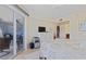 Bright bedroom with a ceiling fan and a large sliding glass door leading to the balcony at 5300 S Atlantic Ave # 14-202, New Smyrna Beach, FL 32169