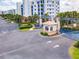 Gated community entrance with well-maintained landscaping and blue arched gate at 5300 S Atlantic Ave # 14-202, New Smyrna Beach, FL 32169