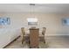 Inviting dining area with stylish chandelier, wicker chairs, and a white sofa at 5300 S Atlantic Ave # 14-202, New Smyrna Beach, FL 32169
