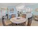 Open dining area with modern lighting, a breakfast bar, and views of the kitchen at 5300 S Atlantic Ave # 14-202, New Smyrna Beach, FL 32169