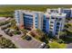 Beautiful exterior view of the condo complex, showcasing manicured landscaping and ample parking at 5300 S Atlantic Ave # 14-202, New Smyrna Beach, FL 32169