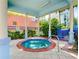 Outdoor hot tub with pergola, columns, and nearby landscaping at 5300 S Atlantic Ave # 14-202, New Smyrna Beach, FL 32169