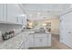 Contemporary kitchen with granite countertops, stainless steel appliances, and white cabinets at 5300 S Atlantic Ave # 14-202, New Smyrna Beach, FL 32169