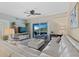 Airy living room featuring a large white sectional sofa, stylish furnishings, and a sliding glass door to a private balcony at 5300 S Atlantic Ave # 14-202, New Smyrna Beach, FL 32169