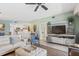 Cozy living room flows into the kitchen, complete with comfortable seating, a stylish TV console, and calming wall color at 5300 S Atlantic Ave # 14-202, New Smyrna Beach, FL 32169