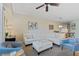 Bright living room with a plush white sectional sofa, unique decor, and comfortable seating, creating an inviting space at 5300 S Atlantic Ave # 14-202, New Smyrna Beach, FL 32169