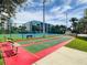 Outdoor shuffleboard court with benches and tennis courts in the background at 5300 S Atlantic Ave # 14-202, New Smyrna Beach, FL 32169