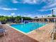 Outdoor swimming pool with waterfall, brick paver deck, and covered seating area at 5300 S Atlantic Ave # 14-202, New Smyrna Beach, FL 32169