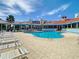 Community swimming pool with lounge chairs and covered outdoor seating at 5300 S Atlantic Ave # 14-202, New Smyrna Beach, FL 32169