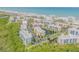 Expansive aerial view of condo community near the beach, with a lake, lush greenery, and ocean views at 5300 S Atlantic Ave # 16-205, New Smyrna Beach, FL 32169