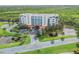 Scenic aerial view of multi-story condo complex featuring ponds and lush greenery in a serene setting at 5300 S Atlantic Ave # 16-205, New Smyrna Beach, FL 32169