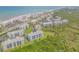 Stunning aerial view of oceanfront condo community with lush landscaping, pools, and beach access at 5300 S Atlantic Ave # 16-205, New Smyrna Beach, FL 32169