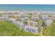 Aerial view of beachfront condos with lush landscaping and ocean backdrop at 5300 S Atlantic Ave # 16-205, New Smyrna Beach, FL 32169