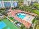 Overhead view of the community clubhouse, pool, tennis courts, and grassy common areas at 5300 S Atlantic Ave # 16-205, New Smyrna Beach, FL 32169