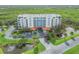 Lovely aerial view of a condo complex with ponds and a fountain in a lush, green environment at 5300 S Atlantic Ave # 16-205, New Smyrna Beach, FL 32169