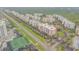 Aerial view of condo community featuring beautiful landscaping, a private pool, and ample parking at 5300 S Atlantic Ave # 16-205, New Smyrna Beach, FL 32169