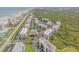 Aerial image showcases a coastal condo complex with verdant common areas and amenities at 5300 S Atlantic Ave # 16-205, New Smyrna Beach, FL 32169