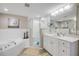 Bathroom featuring soaking tub, walk-in shower, and neutral color palette at 5300 S Atlantic Ave # 16-205, New Smyrna Beach, FL 32169