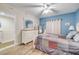 Spacious bedroom featuring wood floors, dresser, and views into en-suite bathroom at 5300 S Atlantic Ave # 16-205, New Smyrna Beach, FL 32169