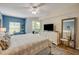 Comfortable bedroom features a TV, dresser and a sliding glass door to the outside at 5300 S Atlantic Ave # 16-205, New Smyrna Beach, FL 32169
