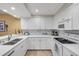 Bright white kitchen features modern appliances, stylish backsplash, and plenty of counter space at 5300 S Atlantic Ave # 16-205, New Smyrna Beach, FL 32169