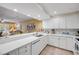 Open kitchen design with a breakfast bar overlooks the living area, enhancing the spacious feel at 5300 S Atlantic Ave # 16-205, New Smyrna Beach, FL 32169